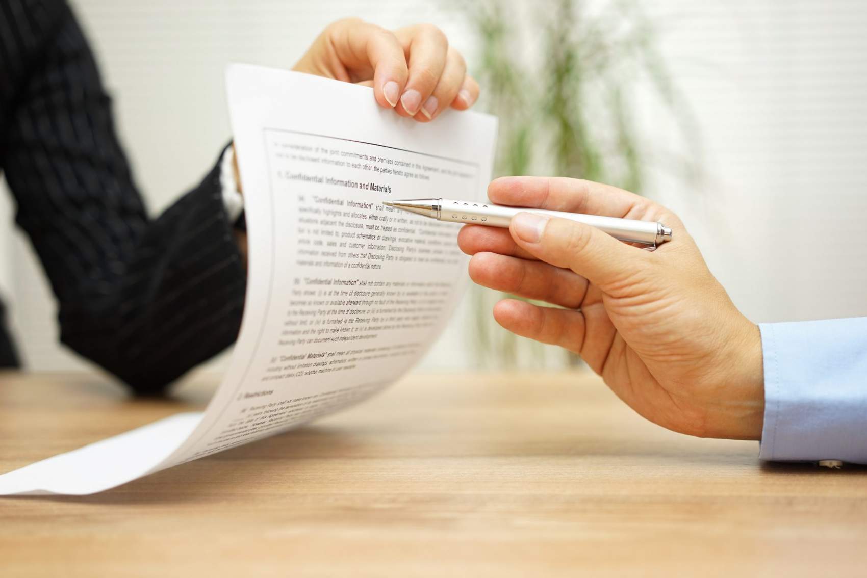 businesswoman holding legal document and  wants an explaination about article in contract