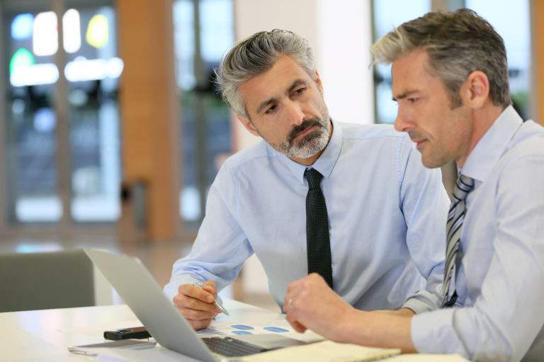Businessmen working in office with laptop